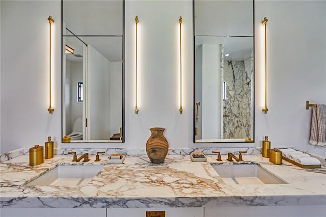 bathroom featuring walk in shower and vanity