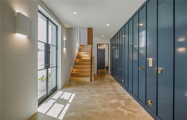 corridor with french doors and light carpet