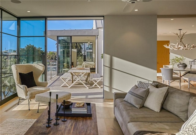 interior space with ceiling fan with notable chandelier and a wealth of natural light