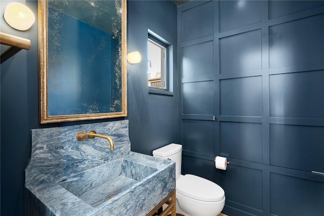 bathroom featuring toilet and vanity