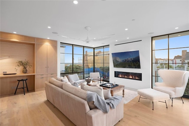 living room with light hardwood / wood-style flooring and expansive windows