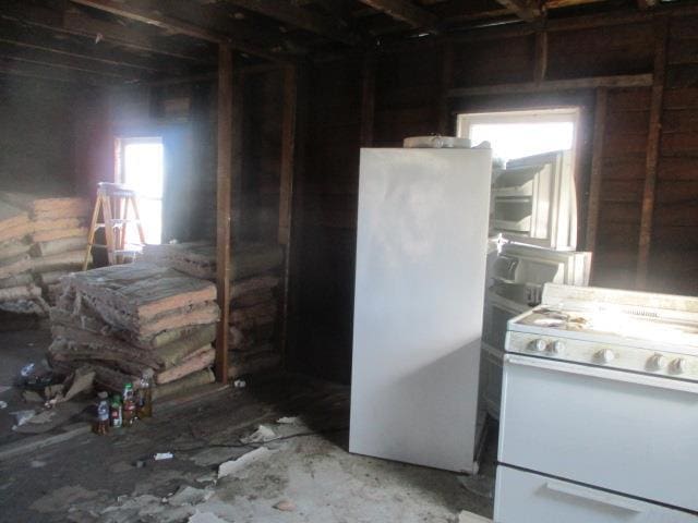 kitchen with refrigerator and white gas range oven