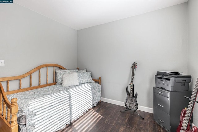 bedroom with dark hardwood / wood-style floors