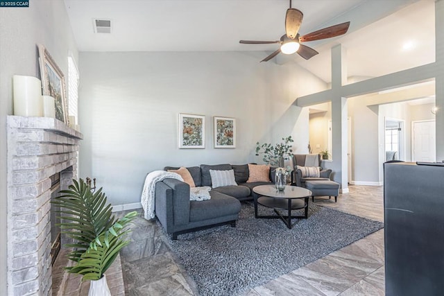 living room featuring ceiling fan, high vaulted ceiling, and a brick fireplace