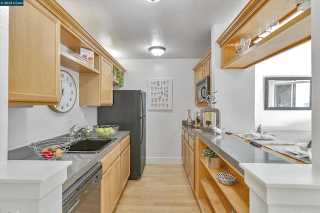 kitchen featuring black appliances, light hardwood / wood-style flooring, light brown cabinetry, and sink