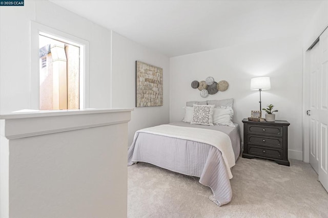 bedroom featuring light carpet