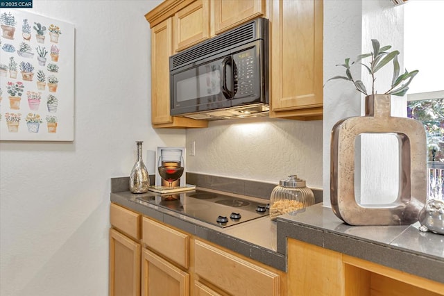 kitchen with light brown cabinetry and stovetop