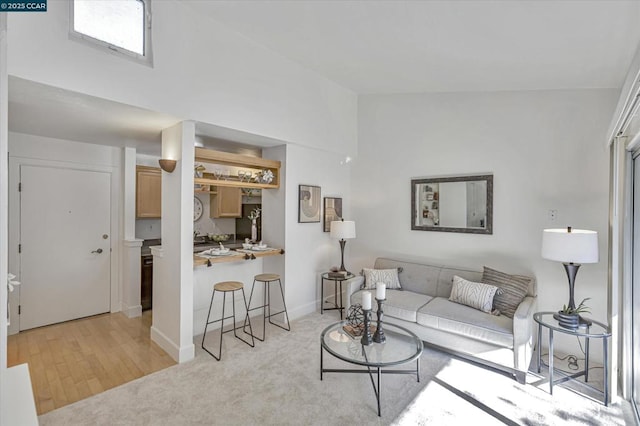 carpeted living room with lofted ceiling