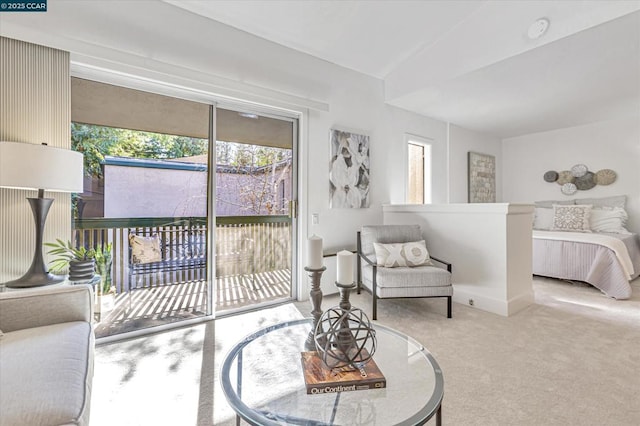 bedroom featuring carpet floors, lofted ceiling, and access to outside