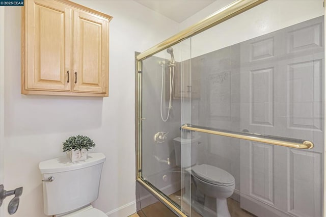 bathroom featuring toilet and enclosed tub / shower combo