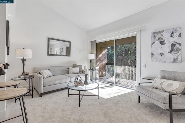 living room featuring high vaulted ceiling and light carpet