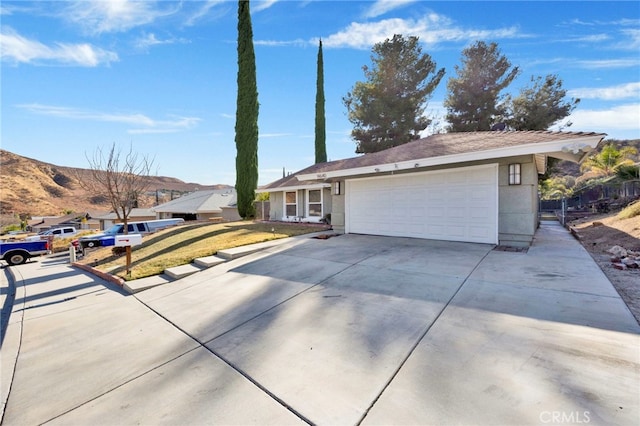 ranch-style home featuring a garage and a front yard