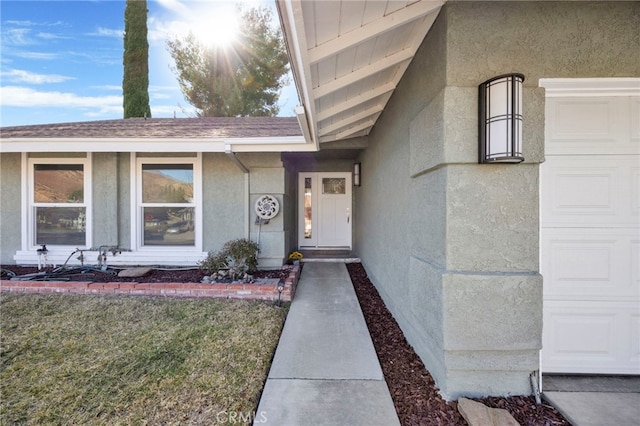 view of exterior entry with a garage