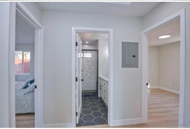 hall featuring electric panel and light wood-type flooring