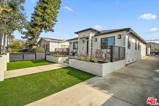 bungalow-style home with a front yard