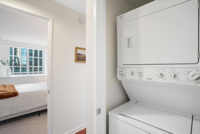 laundry area featuring carpet and stacked washer and clothes dryer