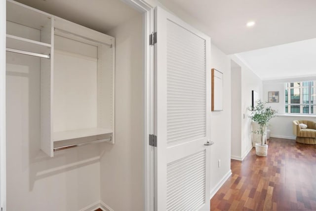 hall with dark wood-type flooring