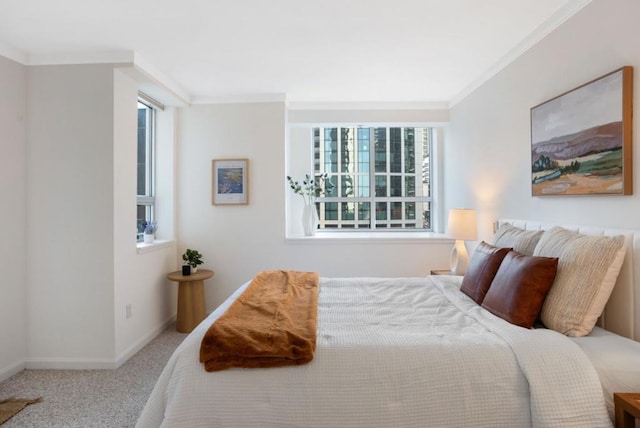 carpeted bedroom featuring crown molding and multiple windows