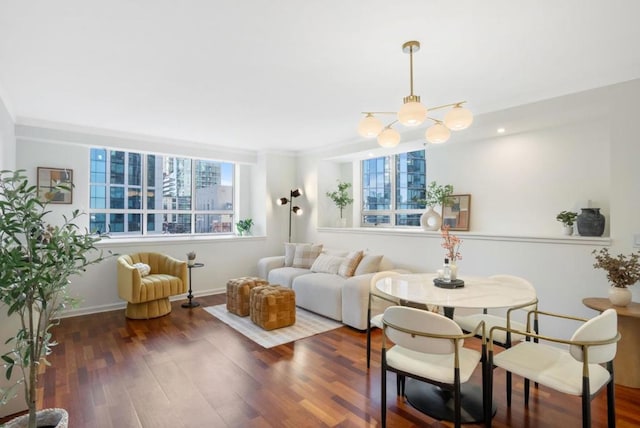 living room with an inviting chandelier and dark wood-type flooring