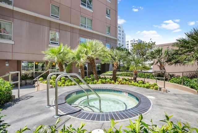 view of pool with a hot tub