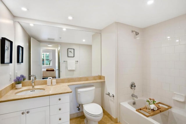 full bathroom with vanity, toilet, tiled shower / bath, and tile patterned floors