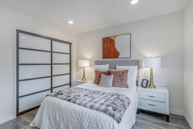 bedroom featuring a closet and light wood-type flooring