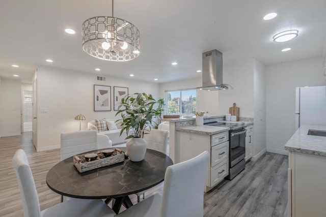 dining room featuring a notable chandelier and light hardwood / wood-style flooring