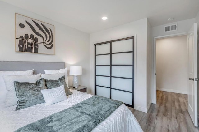 bedroom featuring a closet and light hardwood / wood-style flooring