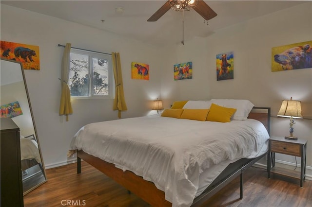 bedroom with ceiling fan and dark hardwood / wood-style floors