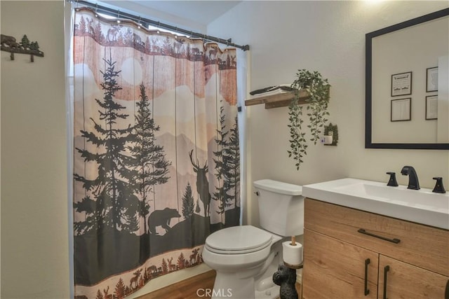 bathroom with hardwood / wood-style flooring, curtained shower, toilet, and vanity