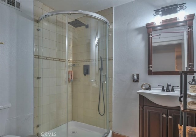 bathroom with vanity and a shower with shower door