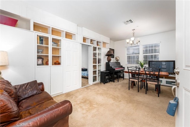 office area with light carpet and an inviting chandelier