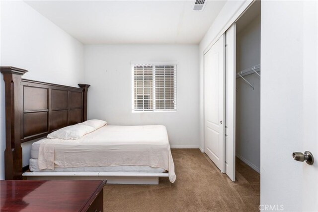 carpeted bedroom featuring a closet