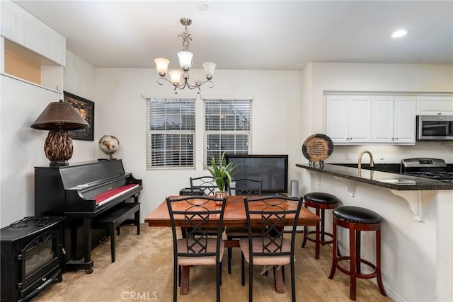 carpeted dining area with sink and an inviting chandelier