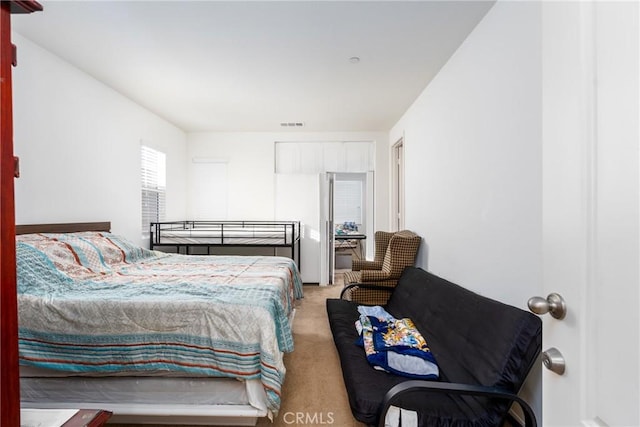 bedroom with light colored carpet