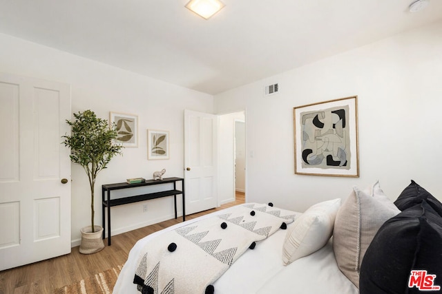 bedroom with hardwood / wood-style floors