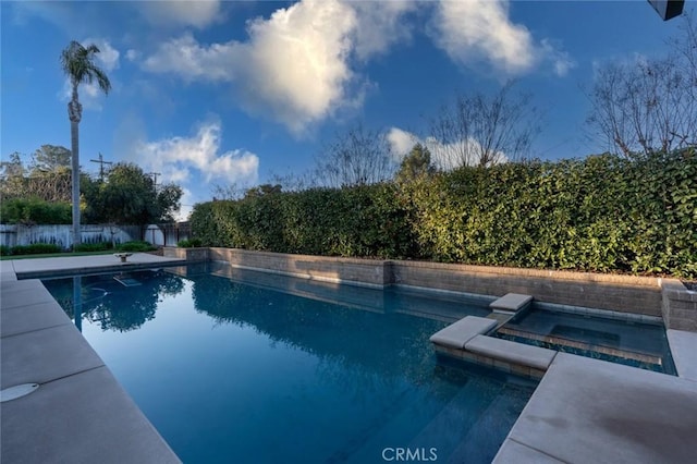 view of pool featuring an in ground hot tub