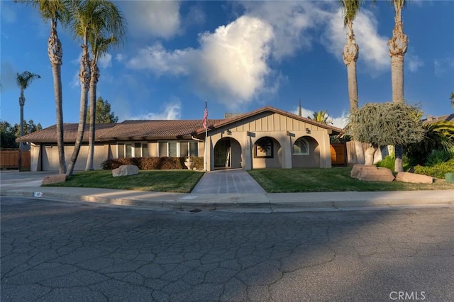 view of front of property with a garage and a front lawn