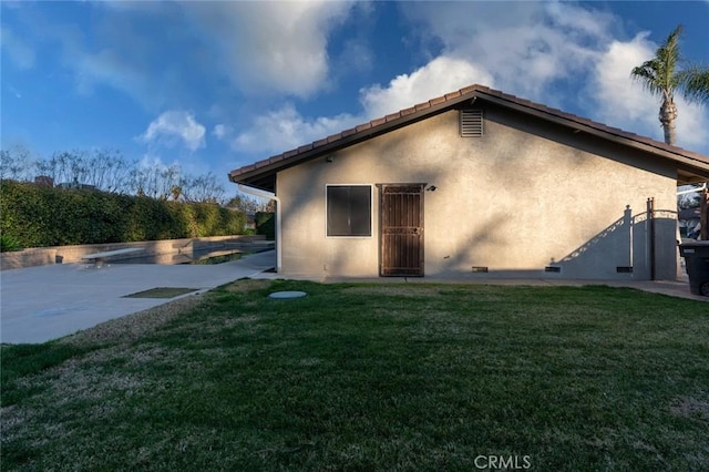 back of property featuring a yard