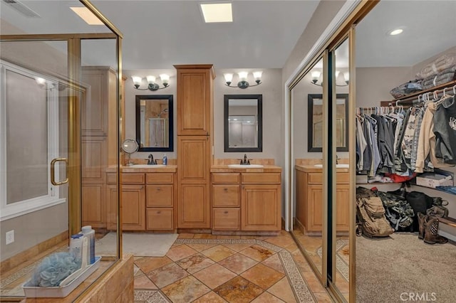 bathroom with walk in shower and vanity