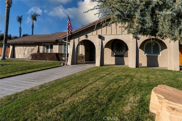 view of front of home with a front yard and a garage