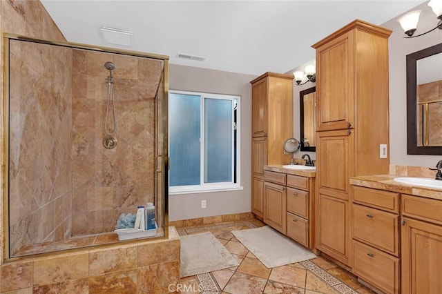 bathroom featuring tile patterned floors, walk in shower, and vanity