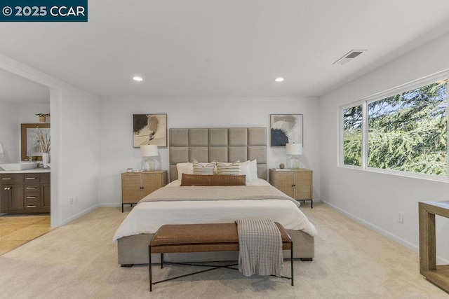 carpeted bedroom featuring connected bathroom