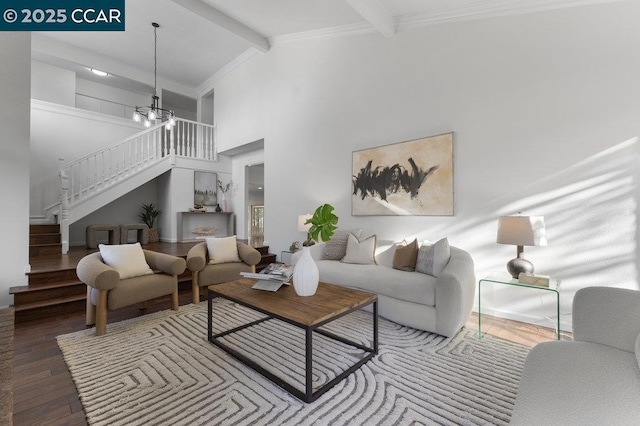 living room with high vaulted ceiling, beamed ceiling, hardwood / wood-style flooring, ornamental molding, and an inviting chandelier