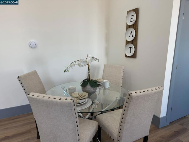 dining room with dark wood-type flooring