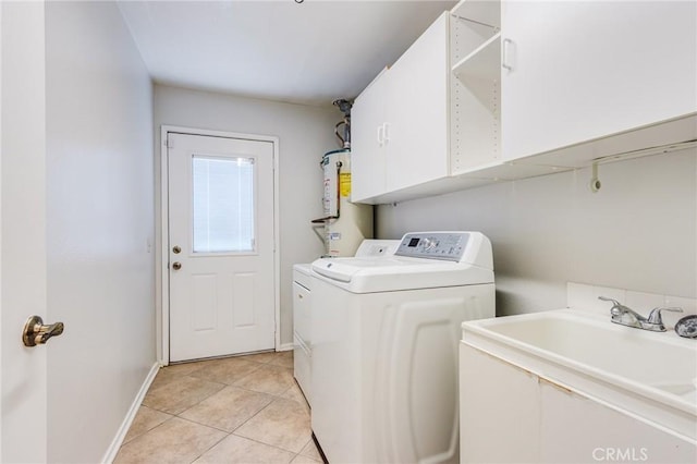 clothes washing area featuring gas water heater, light tile patterned flooring, a sink, washer and dryer, and laundry area