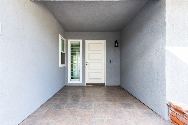 view of exterior entry with stucco siding