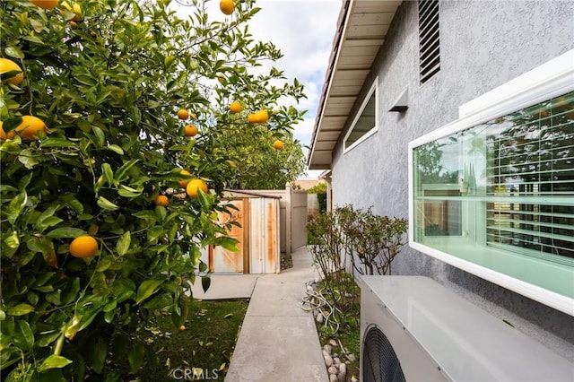 view of home's exterior featuring fence and stucco siding