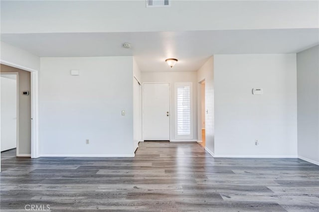 foyer with visible vents, baseboards, and wood finished floors