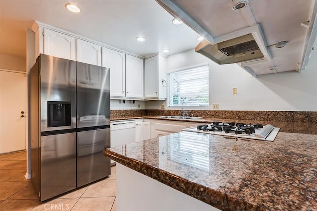 kitchen featuring light tile patterned floors, recessed lighting, white cabinets, a sink, and white appliances